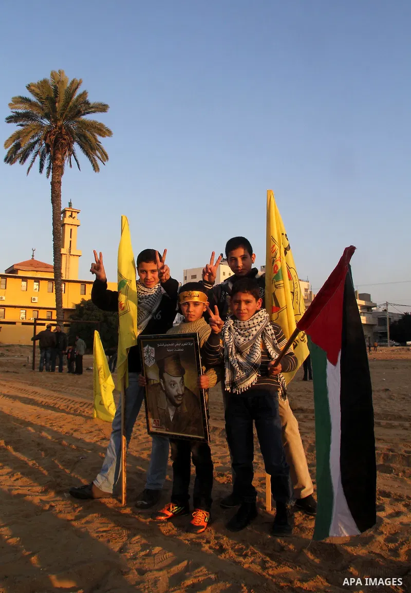 Palestinian supporters of Fatah movement hold the party's flags during a rally in Gaza city on December 31, 2012. The Gaza branch of Palestinian president Mahmud Abbas's Fatah party said on Friday it will mark its annive...
