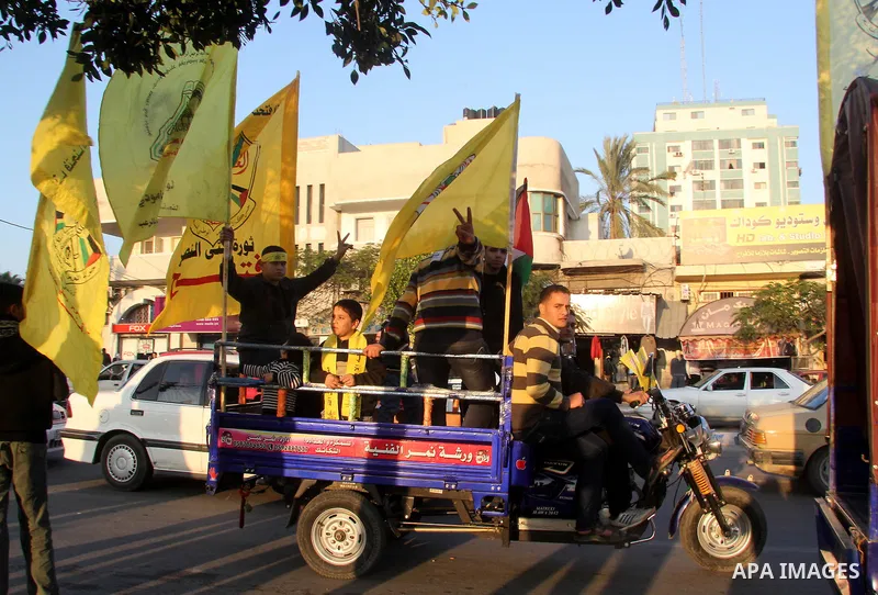 Palestinian supporters of Fatah movement hold the party's flags during a rally in Gaza city on December 31, 2012. The Gaza branch of Palestinian president Mahmud Abbas's Fatah party said on Friday it will mark its annive...
