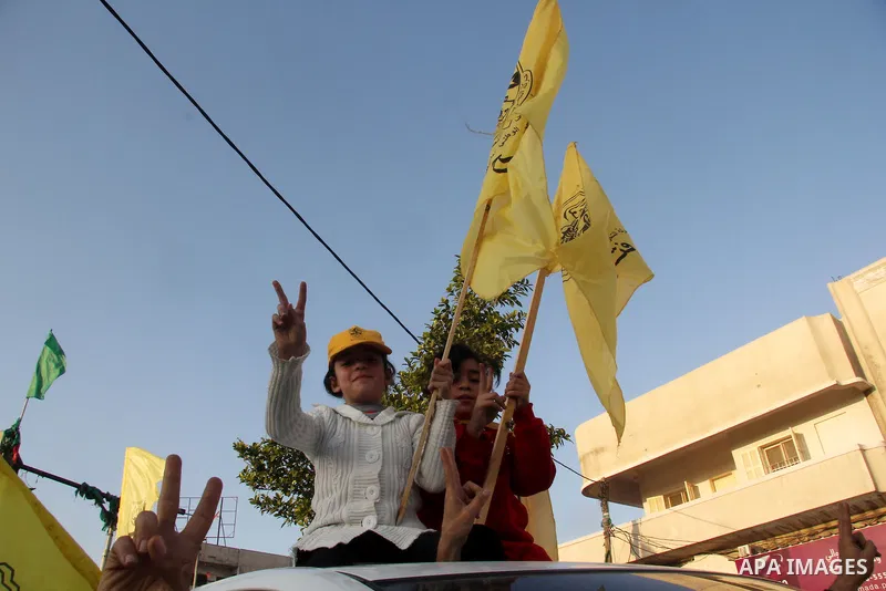 Palestinian children mark victory sign during a rally in Gaza city on December 31, 2012. The Gaza branch of Palestinian president Mahmud Abbas's Fatah party said on Friday it will mark its anniversary in the Hamas-ruled...