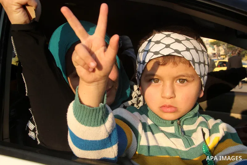 A Palestinian child marks victory sign during a rally in Gaza city on December 31, 2012. The Gaza branch of Palestinian president Mahmud Abbas's Fatah party said on Friday it will mark its anniversary in the Hamas-ruled...