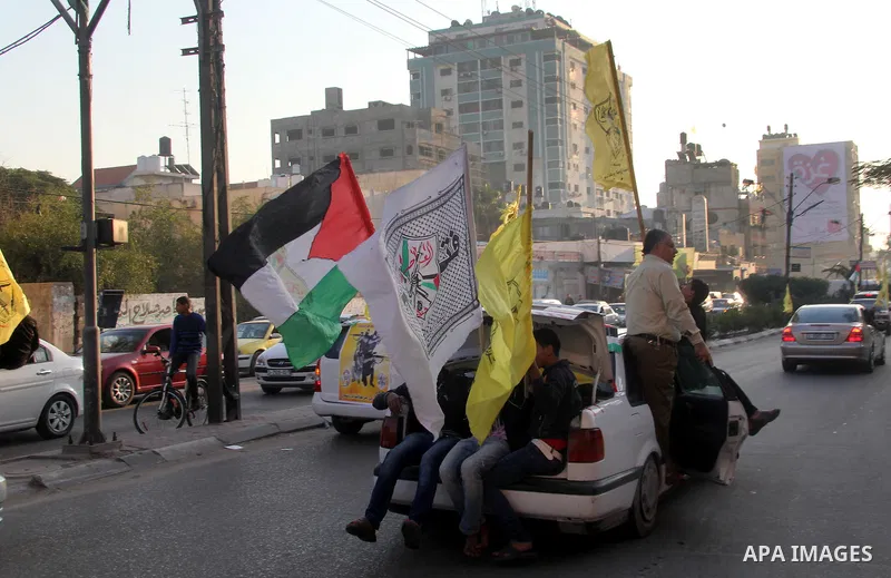 Palestinian supporters of Fatah movement hold the party's flags during a rally in Gaza city on December 31, 2012. The Gaza branch of Palestinian president Mahmud Abbas's Fatah party said on Friday it will mark its annive...