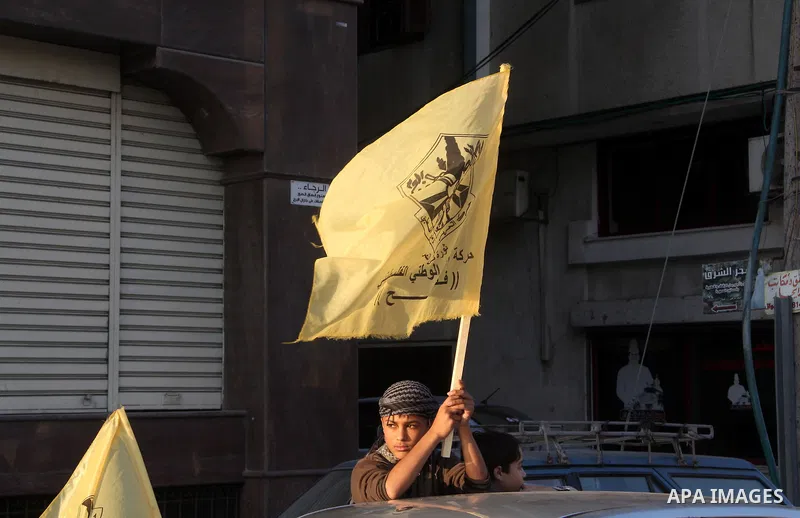 A Palestinian supporter of Fatah movement holds the party's flag during a rally in Gaza city on December 31, 2012. The Gaza branch of Palestinian president Mahmud Abbas's Fatah party said on Friday it will mark its anniv...