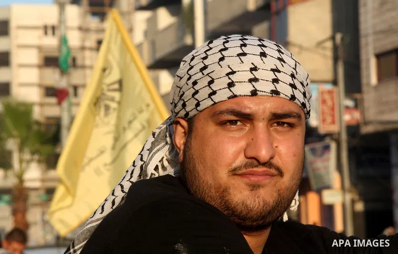 A Palestinian supporter of Fatah movement holds the party's flag during a rally in Gaza city on December 31, 2012. The Gaza branch of Palestinian president Mahmud Abbas's Fatah party said on Friday it will mark its anniv...