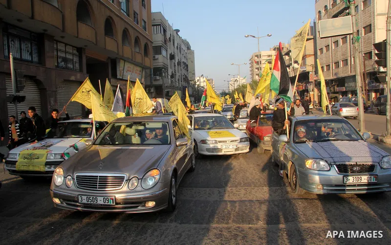 Palestinian supporters of Fatah movement hold the party's flags during a rally in Gaza city on December 31, 2012. The Gaza branch of Palestinian president Mahmud Abbas's Fatah party said on Friday it will mark its annive...