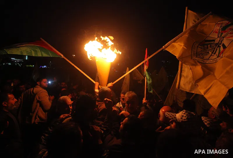 Palestinian supporters of Fatah movement hold the party's torch during a rally in Gaza city on December 31, 2012. The Gaza branch of Palestinian president Mahmud Abbas's Fatah party said on Friday it will mark its annive...