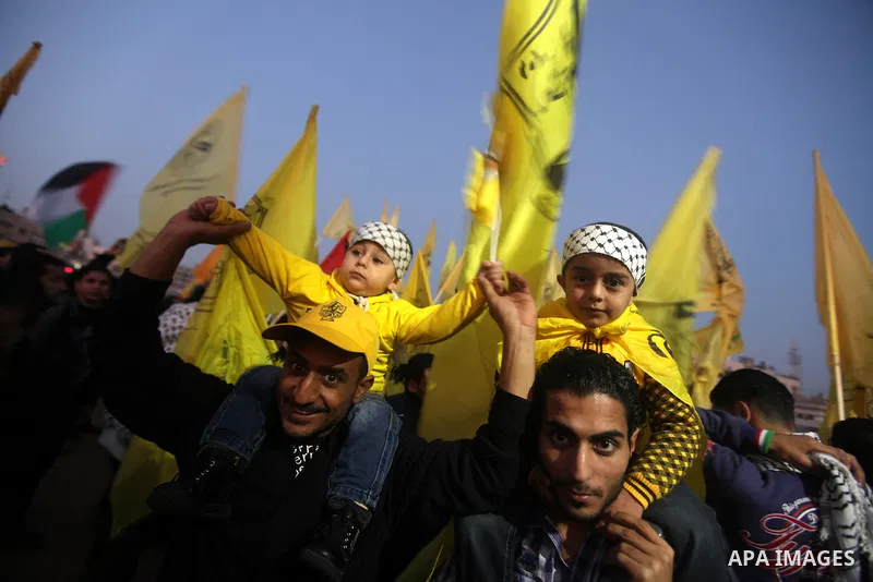 Palestinian supporters of Fatah movement hold the party's flags during a rally in Gaza city on December 31, 2012. The Gaza branch of Palestinian president Mahmud Abbas's Fatah party said on Friday it will mark its annive...