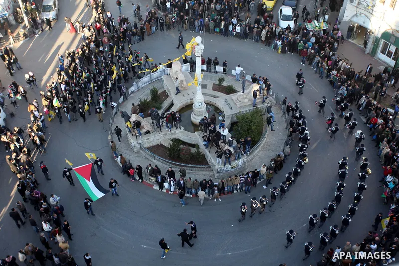Palestinians wave their national flag during a rally on the eve of the 48th anniversary of the formation on the Fatah movement, on December 31, 2012, in the West Bank city of Ramallah. The Fatah anniversary commemorates...