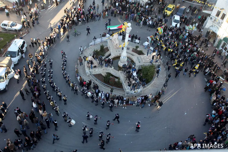 Palestinians wave their national flag during a rally on the eve of the 48th anniversary of the formation on the Fatah movement, on December 31, 2012, in the West Bank city of Ramallah. The Fatah anniversary commemorates...