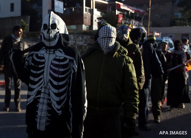Palestinian supporters of Fatah movement wear military clothes as they march during a rally on the eve of the 48th anniversary of the formation on the Fatah movement, on December 31, 2012, in the West Bank city of Ramall...