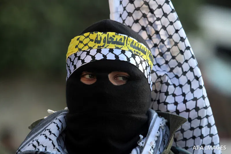 A Palestinian supporter of Fatah movement wears military clothes as they march during a rally on the eve of the 48th anniversary of the formation on the Fatah movement, on December 31, 2012, in the West Bank city of Rama...