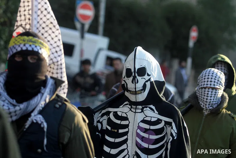 Palestinian supporters of Fatah movement wear military clothes as they march during a rally on the eve of the 48th anniversary of the formation on the Fatah movement, on December 31, 2012, in the West Bank city of Ramall...