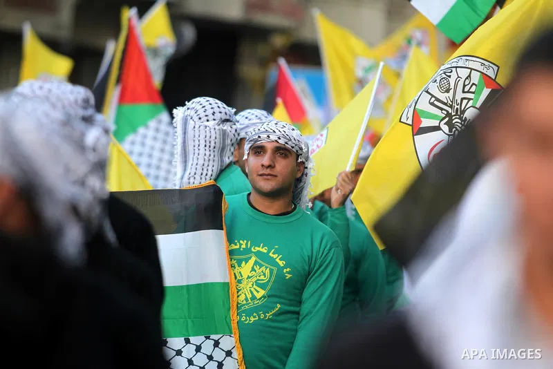 Palestinians wave their national flag during a rally on the eve of the 48th anniversary of the formation on the Fatah movement, on December 31, 2012, in the West Bank city of Ramallah. The Fatah anniversary commemorates...