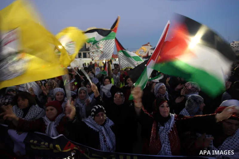 Palestinians wave their national flag during a rally on the eve of the 48th anniversary of the formation on the Fatah movement, on December 31, 2012, in the West Bank city of Ramallah. The Fatah anniversary commemorates...