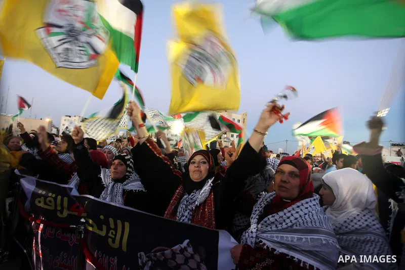 Palestinians wave their national flag during a rally on the eve of the 48th anniversary of the formation on the Fatah movement, on December 31, 2012, in the West Bank city of Ramallah. The Fatah anniversary commemorates...