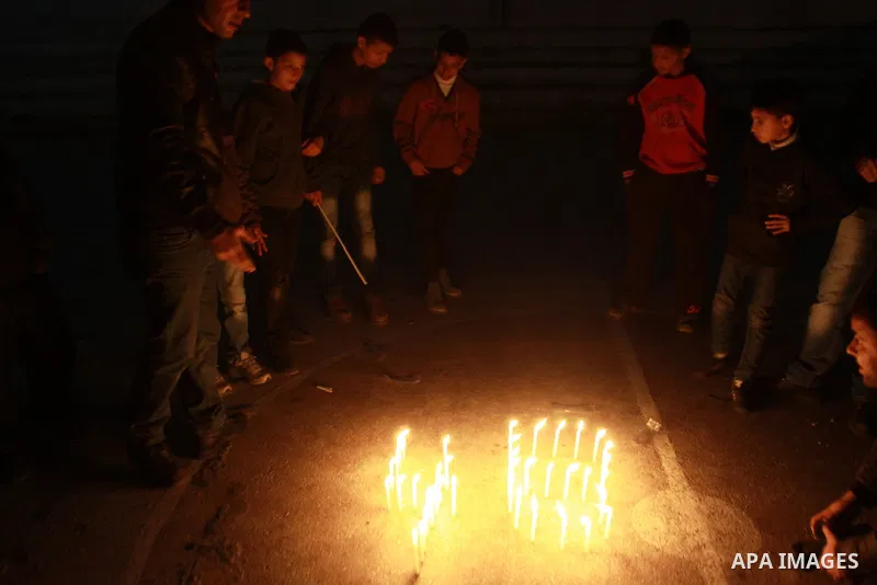 Palestinian supporters of Fatah movement place candles during a rally on the eve of the 48th anniversary of the formation on the Fatah movement, on December 31, 2012, in the West Bank city of Nablus. The Fatah anniversar...
