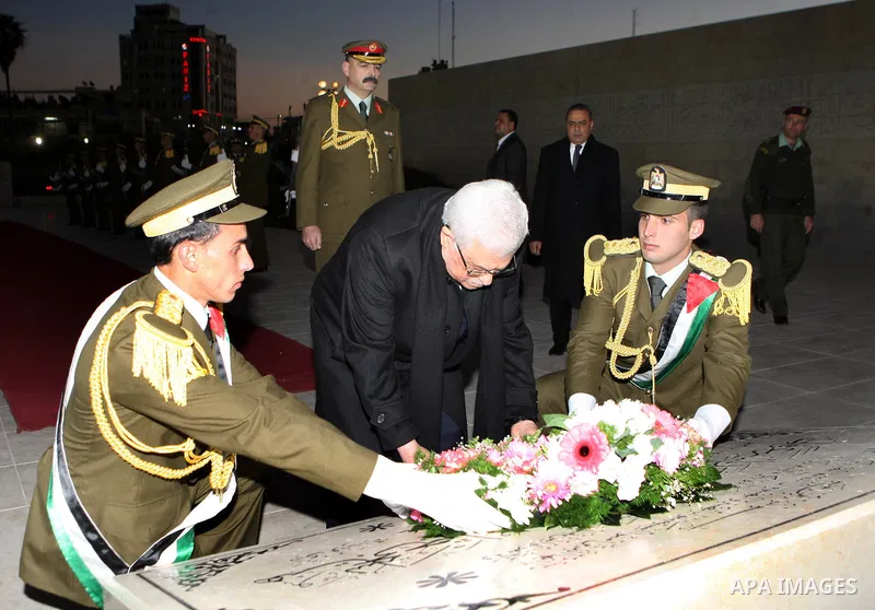 Palestinian president lays a floral wreath on the former Palestinian leader grave Yasser Arafat, on the eve of the 48th anniversary of the formation on the Fatah movement, on December 31, 2012, in the West Bank city of R...