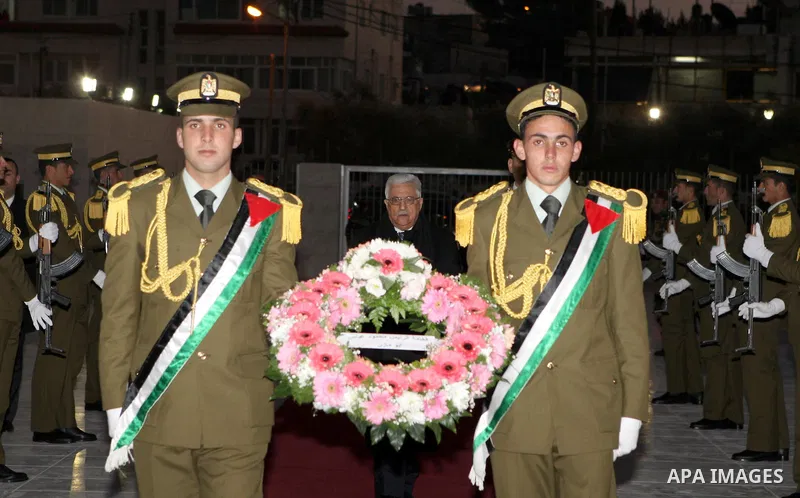 Palestinian president lays a floral wreath on the former Palestinian leader grave Yasser Arafat, on the eve of the 48th anniversary of the formation on the Fatah movement, on December 31, 2012, in the West Bank city of R...