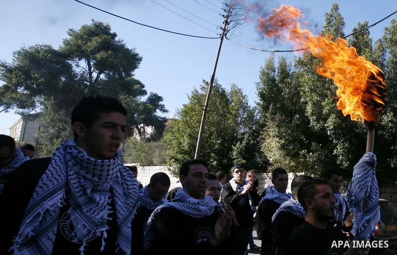 Palestinian supporters of Fatah movement hold torch as they celebrate the 48th anniversary of the founding of Fatah movement in Jerusalem December 31, 2012. Photo by Mahfouz Abu Turk