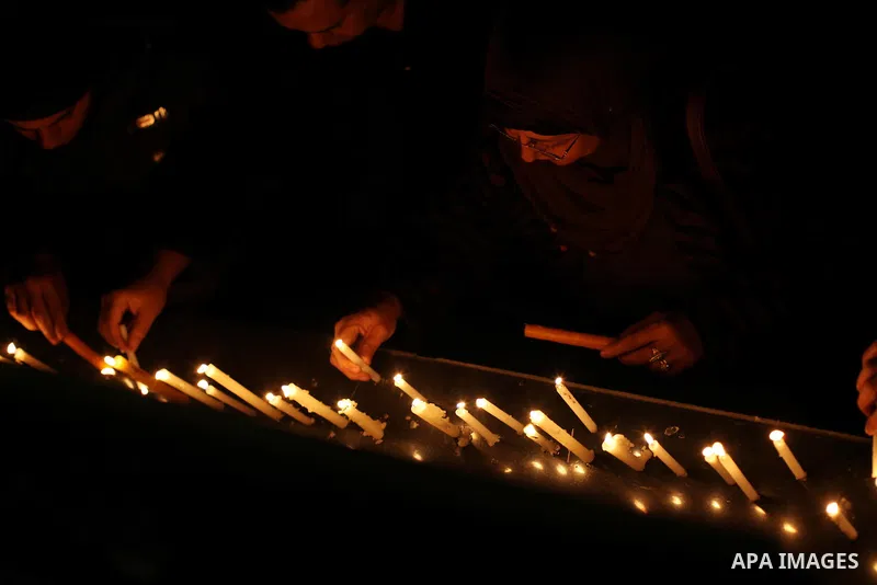 Egyptian activists light candles at the entrance of the Journalist's Syndicate in Cairo on December 31, 2012, during a rally to commemorate the anniversary of the car bomb attack on the al-Qiddissine (The Saints) church...
