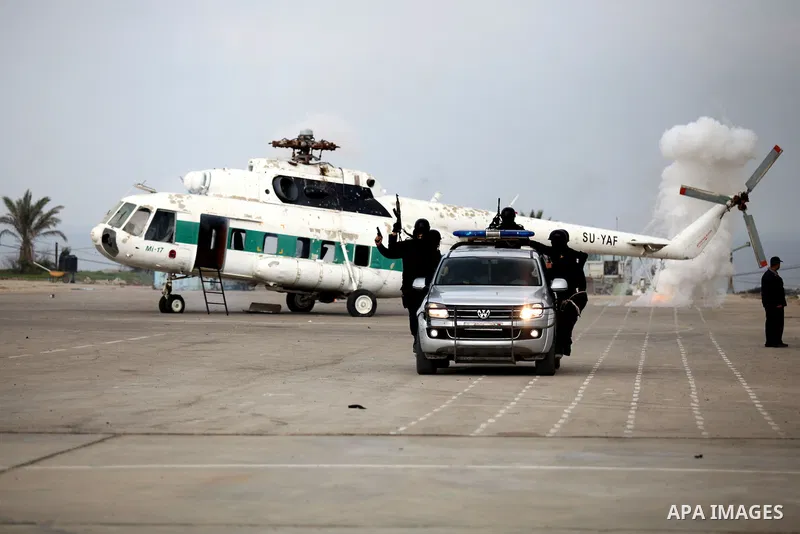 Palestinian members of Hamas' special security unit demonstrate freeing hostages from a hijacked helicopter during a graduation ceremony Batch of the leader Salah El Din Ayoubi for members of Hamas security forces in Gaz...