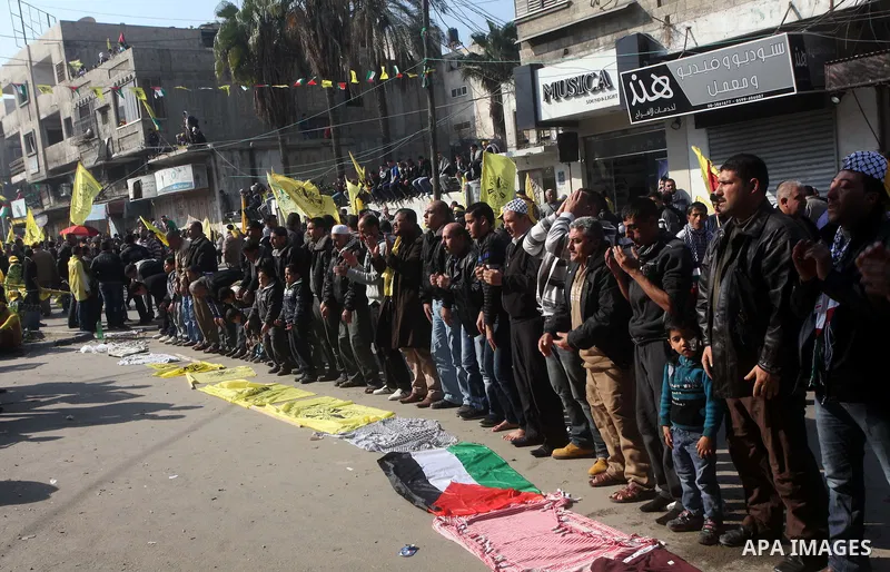 Palestinians pray during a rally marking the 48th anniversary of the founding of the Fatah movement, in Gaza City January 4, 2013. Hundreds of thousands of Palestinians joined a rare rally staged by President Mahmoud Abb...