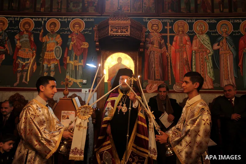 Greek Archbishop Alexious, leads prayers during Christmas celebrations on January 7, 2013 in Gaza City. According to the Gregorian calendar, Orthodox Christmas falls 13 days after the December 25 Western feast celebrated...