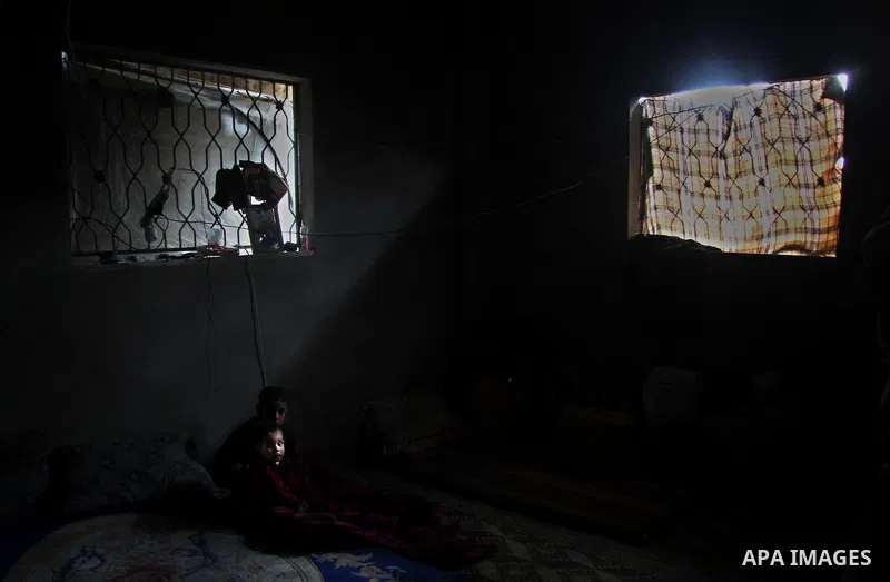 Palestinian children sit at their house during the heavy storm in a poor neighborhood in Gaza city, Jan. 9, 2013. Palestinian poor families faced further misery due to increasing shortages of supplies, low temperatures,...