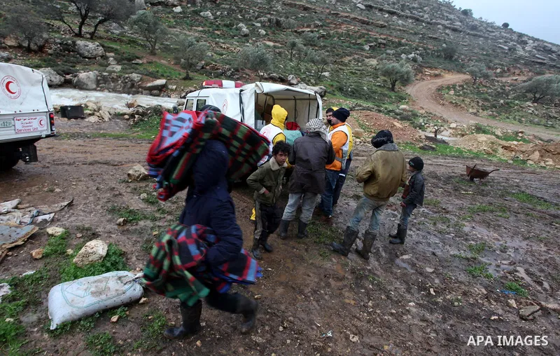 Palestinian Bedouins try to save their belongings from the flooded tents in the village of Ein Qiniya near the West Bank city of Ramallah, Jan. 9, 2013. Extreme weather, including torrential rains and heavy winds, killed...