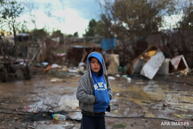 A Palestinian bedouin child stands outside his shack on a windy winter day in the central Gaza Strip January 10, 2013. A storm has hit the eastern Mediterranean coast and heavy rains with flooding are forecast in Israel...