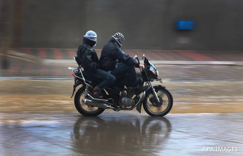 Palestinians ride motorcycle through floodwater in the central Gaza Strip January 10, 2013. A storm has hit the eastern Mediterranean coast and heavy rains with flooding are forecast in Israel and the Palestinian territo...
