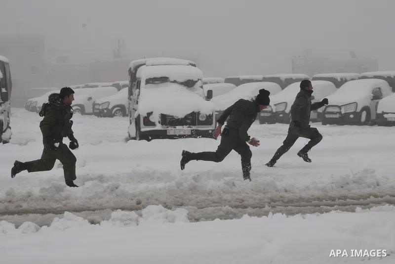 Palestinian security personnel engage in a snowball fight near their headquarters in the West Bank city of Hebron 10 January 2013. The higher elevations in the Palestinian Authority areas and Israel, including Jerusalem,...