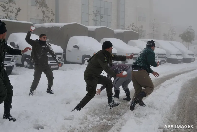 Palestinian security personnel engage in a snowball fight near their headquarters in the West Bank city of Hebron 10 January 2013. The higher elevations in the Palestinian Authority areas and Israel, including Jerusalem,...
