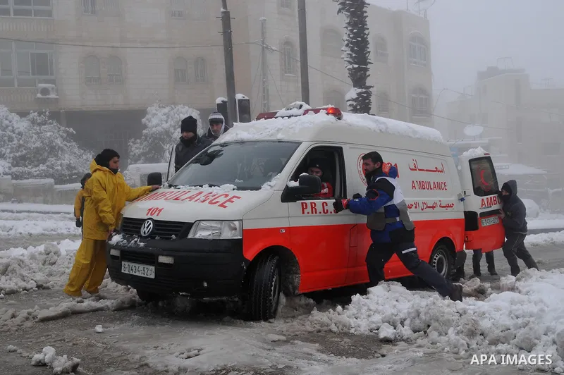 An ambulance equipped to tackle snowy conditions drives outside of the Ibrahami Mosque or the Tomb of the Patriarchs in the West Bank City of Hebron as wintry weather swept through the region 10 January 2013. Photo by Ma...