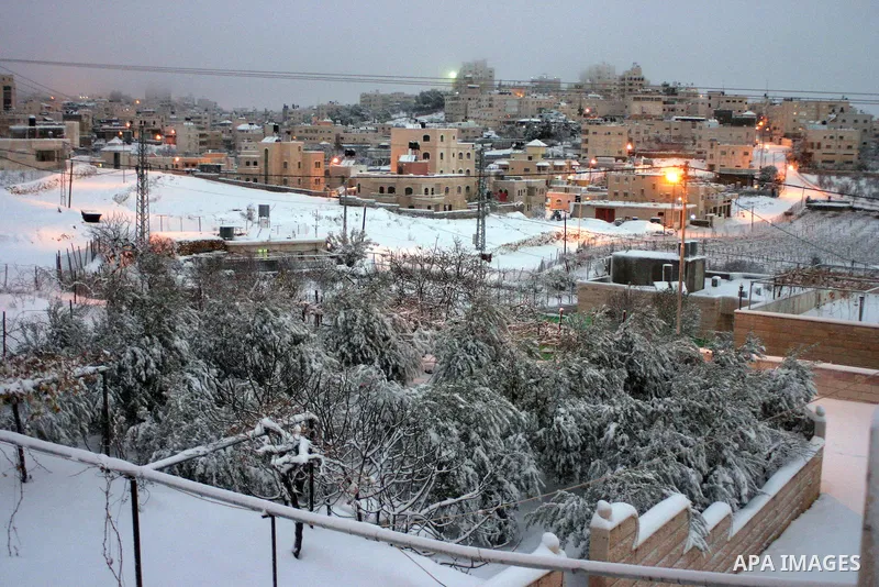 A general view shows the snow falls in the West Bank city of Hebron on January 10, 2013. Abnormal storms, which for four days have blasted the Middle East with rain, snow and hail, leave swathes of Israel and Jordan unde...