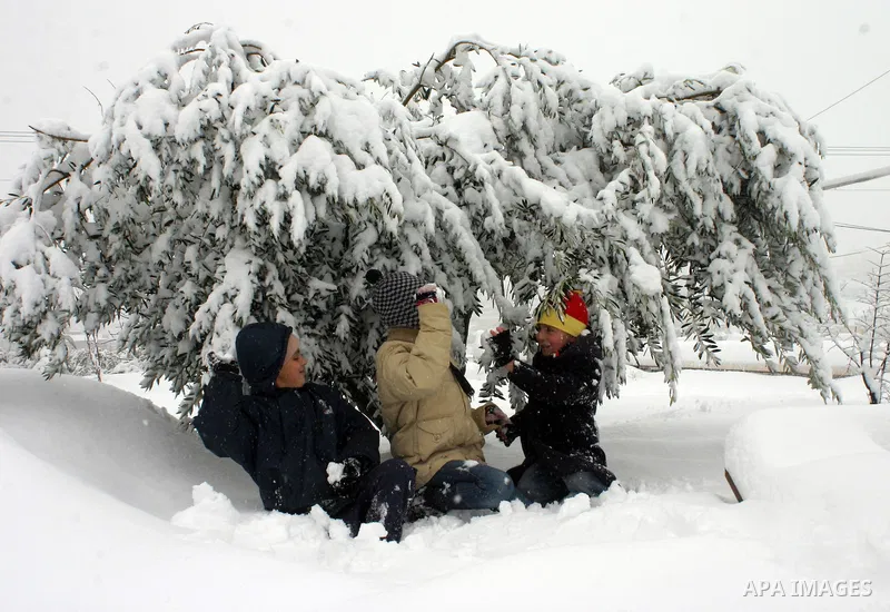 Palestinian children in the snow balls in the West Bank city of Hebron on January 10, 2013. Abnormal storms, which for four days have blasted the Middle East with rain, snow and hail, leave swathes of Israel and Jordan u...