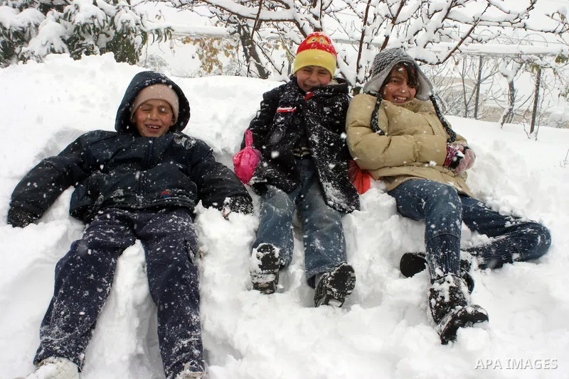Palestinian children in the snow balls in the West Bank city of Hebron on January 10, 2013. Abnormal storms, which for four days have blasted the Middle East with rain, snow and hail, leave swathes of Israel and Jordan u...
