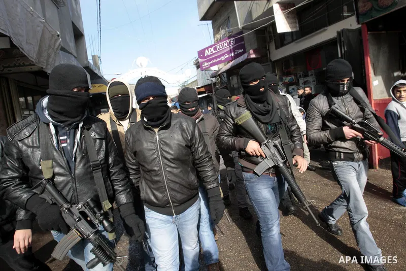 Palestinian members of the Al-Aqsa Martyrs Brigades, a group loyal to Palestinian leader Mahmoud Abbas' Fatah movement march in the Balata refugee camp in the West Bank, Thursday, Jan. 10, 2013. The men were protesting a...