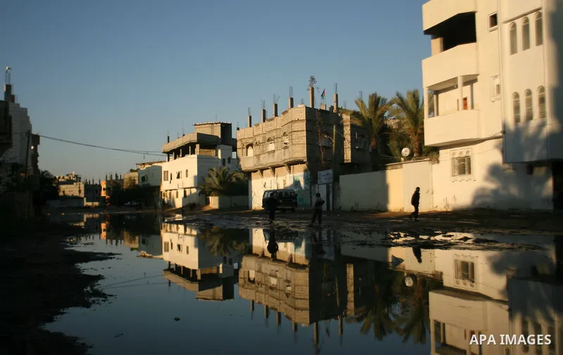 Palestinian children walk past a flooded street after heavy storms in Rafah refugee camp southern Gaza strip on 11 january 2013. In Gaza, cold weather and heavy rain flooded several of the tunnels running between the ter...