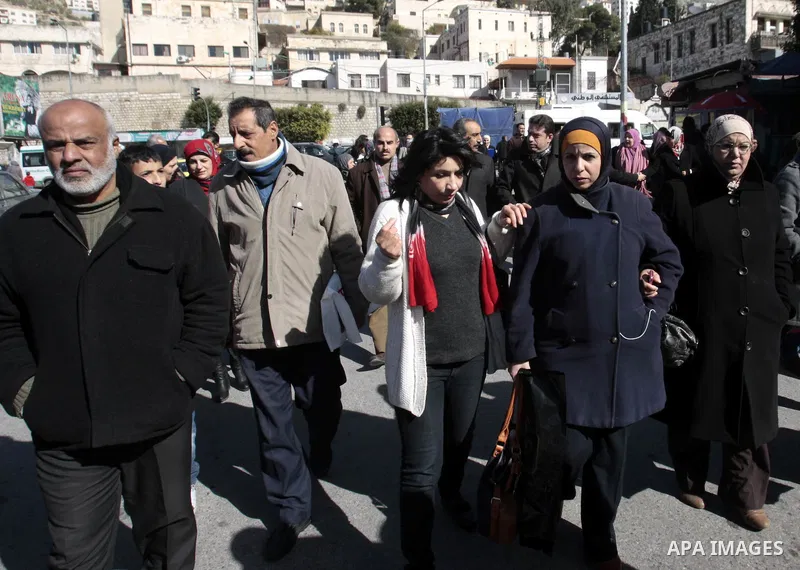Palestinian employees hold placards during a protest to demand the Palestinian government to pay their salaries, in the West Bank city of Nablus on 15 January 2013. Palestinian Prime Minister Salam Fayyad warned Sunday t...