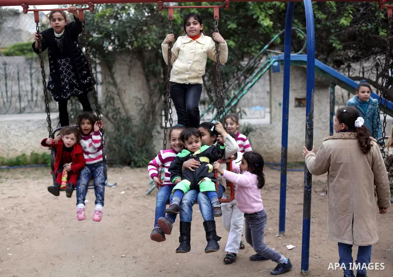 Palestinian children play at a park during the semester break, in Gaza city on 16 January 2013. Photo by Ashraf Amra