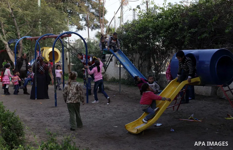 Palestinian children play at a park during the semester break, in Gaza city on 16 January 2013. Photo by Ashraf Amra