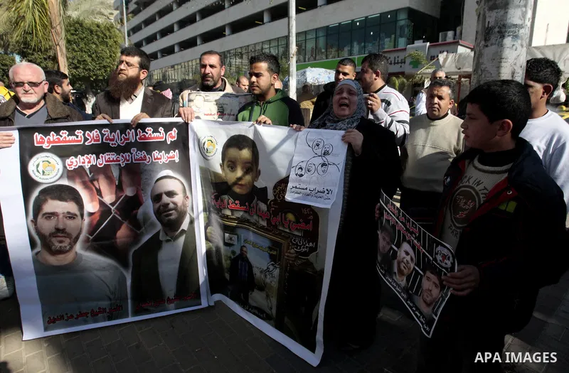 Palestinians attend a rally calling for the release of two Palestinian prisoners in Israeli jails, in the West Bank city of Nablus on Jan. 19, 2013. The two prisoners, Ayman Sharawneh and Samer Isawi, have been going on...