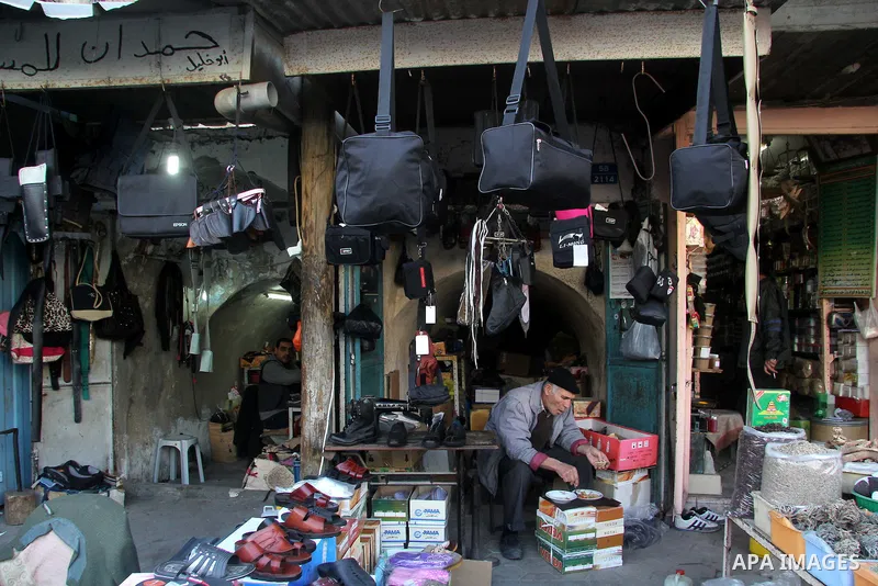 A Palestinian vendor eats in front of his shop at al-Zawiya popular market in Gaza city, January 20, 2013. Photo by Ezz al-Zanoon