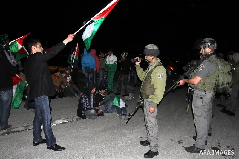 Israeli soldiers prevent Palestinian activists from accessing to the newly erected encampment set up to protest against Israel's intention to confiscate land on January 20, 2013 at Beit Iksa checkpoint, in the West Bank...
