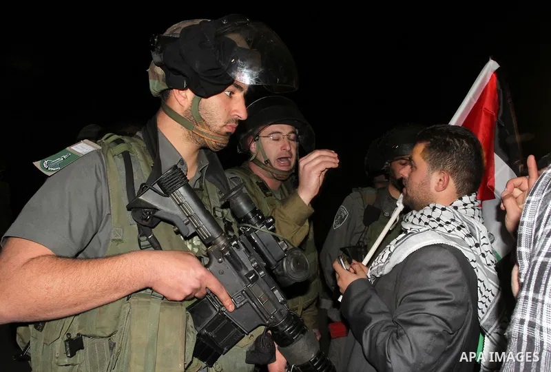 Israeli soldiers prevent Palestinian activists from accessing to the newly erected encampment set up to protest against Israel's intention to confiscate land on January 20, 2013 at Beit Iksa checkpoint, in the West Bank...