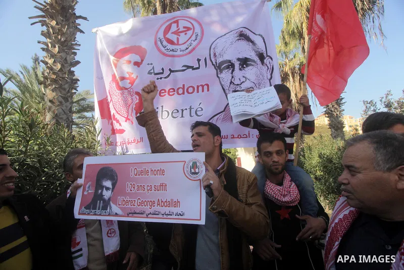 Palestinian supporters of the Popular Front for the Liberation of Palestine (PFLP) take part in a protest outside the French Cultural Center calling for the release of Lebanese militant Georges Ibrahim Abdallah (portrait...