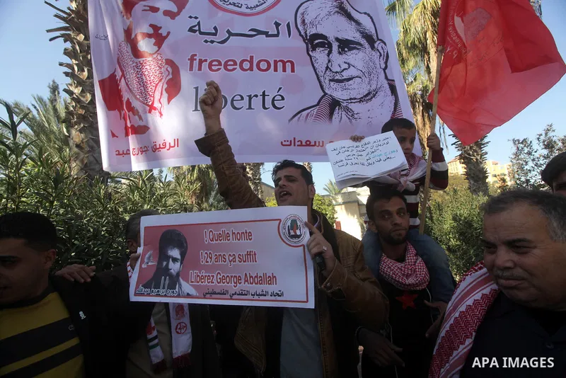 Palestinian supporters of the Popular Front for the Liberation of Palestine (PFLP) take part in a protest outside the French Cultural Center calling for the release of Lebanese militant Georges Ibrahim Abdallah (portrait...