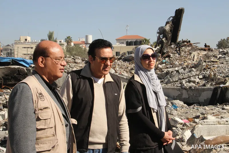 Egyptian actors Hanan Turk and Tarek Dusouqi stand on the rubble of a house which destroyed in a past Israeli air strike, in Gaza city on January 21, 2013. Turk and Dusouqi visit Gaza strip with a delegation representing...