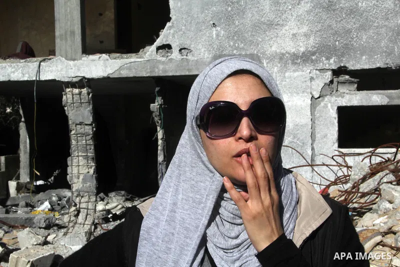 Egyptian actor Hanan Turk reacts near the rubble of a house which destroyed in a past Israeli air strike, in Gaza city on January 21, 2013. Turk and Tarek Dusouqi visit Gaza strip with a delegation representing Islamic R...