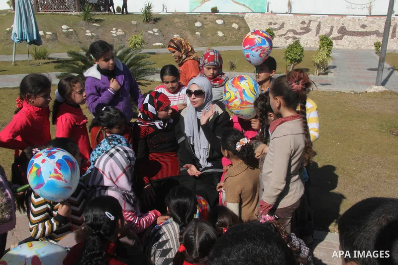 Egyptian actor Hanan Turk sings to Palestinian children in a park, in Gaza city on January 21, 2013. Turk and Tarek Dusouqi visit Gaza strip with a delegation representing Islamic Relief Worldwide. Turk said she has been...